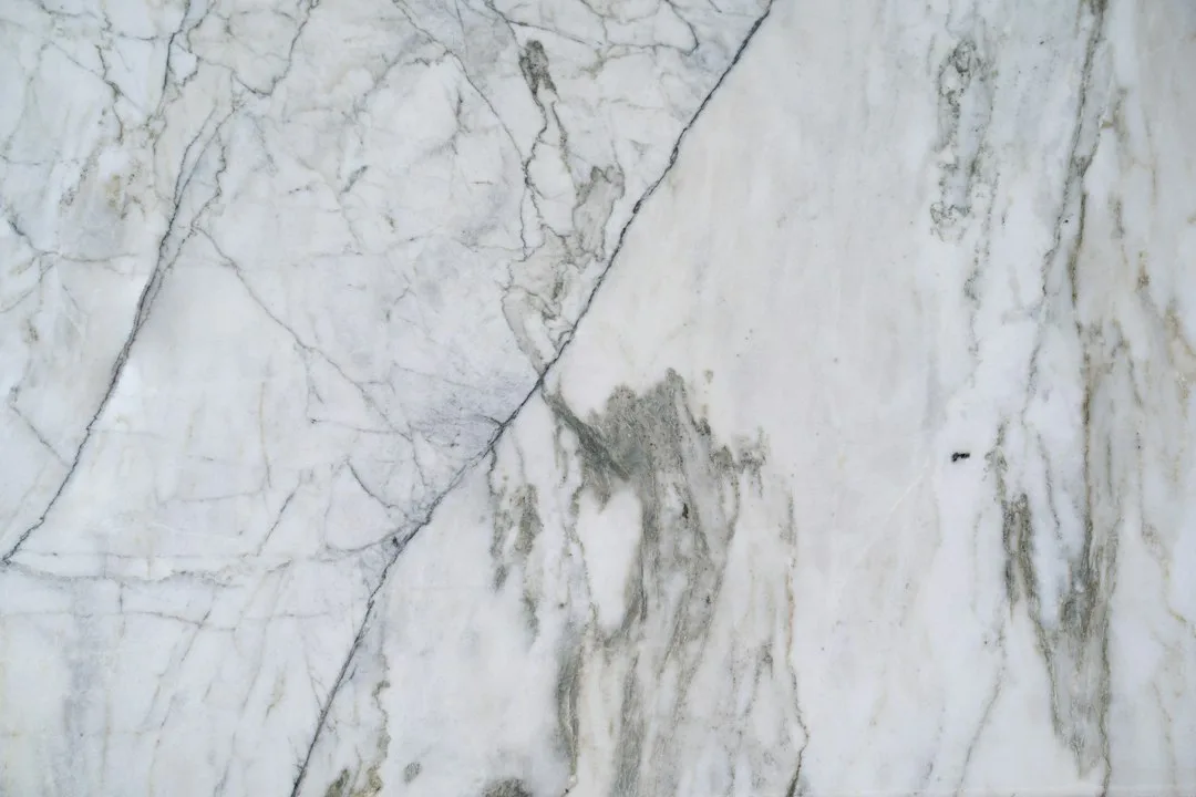 Rows of upright stone slabs in a daylit warehouse